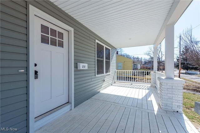 wooden terrace featuring covered porch