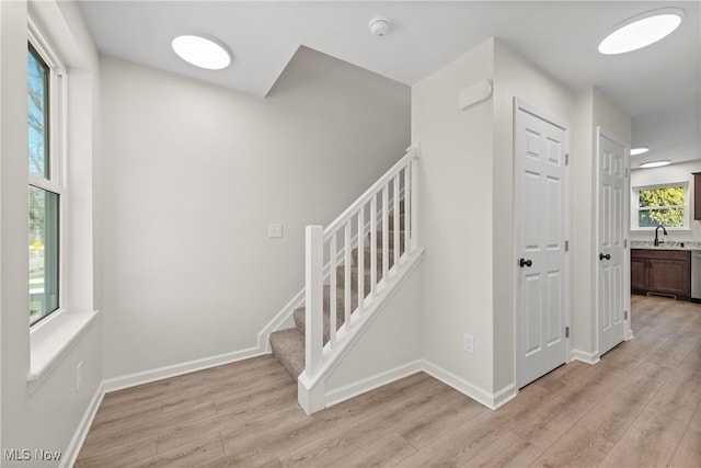 stairway with baseboards and wood finished floors