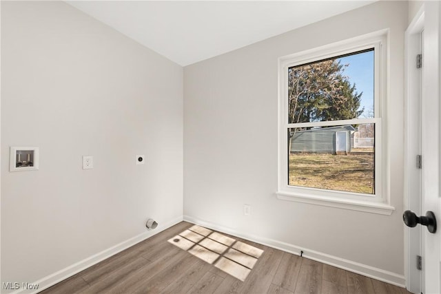 empty room featuring baseboards and wood finished floors