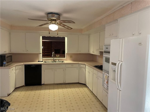 kitchen with white appliances, a ceiling fan, light countertops, and a sink