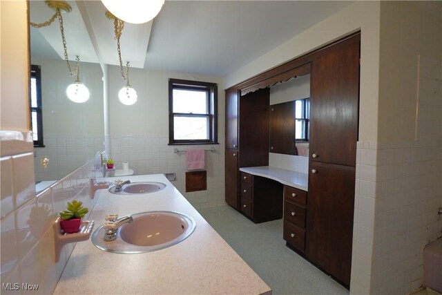3390 Meese Rd NE, Louisville, OH 44641 - bathroom with a sink, a wainscoted wall, tile walls, and double vanity