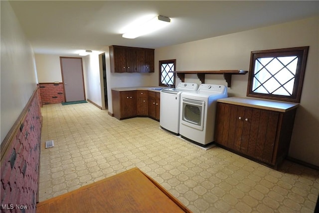 3390 Meese Rd NE, Louisville, OH 44641 - clothes washing area featuring washer and dryer, cabinet space, light floors, and a sink