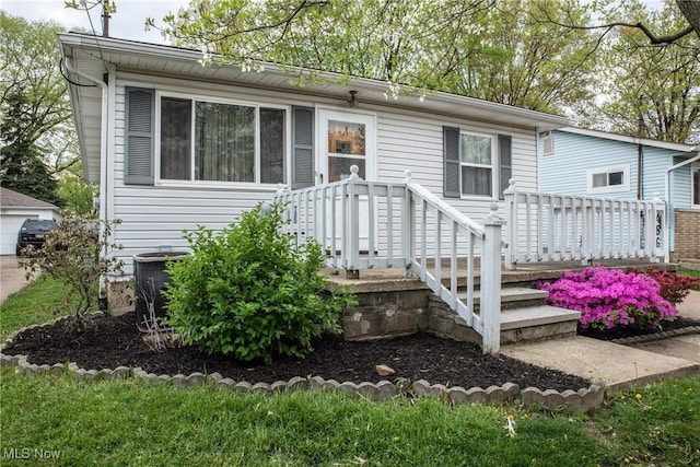 view of front of house featuring a garage and central AC