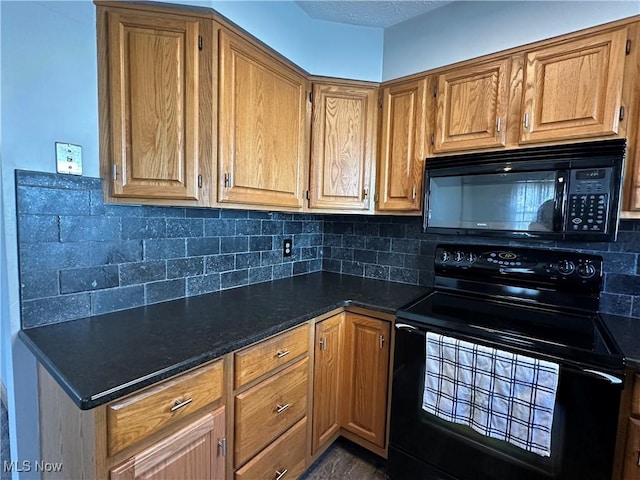 kitchen featuring dark countertops, backsplash, black appliances, and brown cabinetry