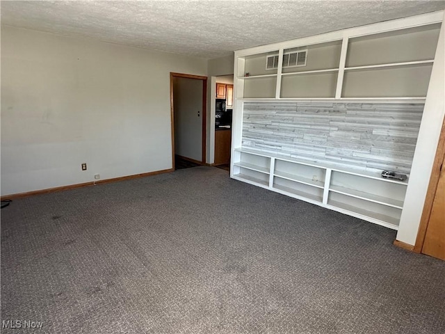 unfurnished living room featuring visible vents, a textured ceiling, baseboards, and dark colored carpet