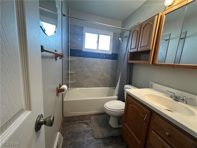 full bathroom with visible vents, toilet, shower / bath combo, and vanity