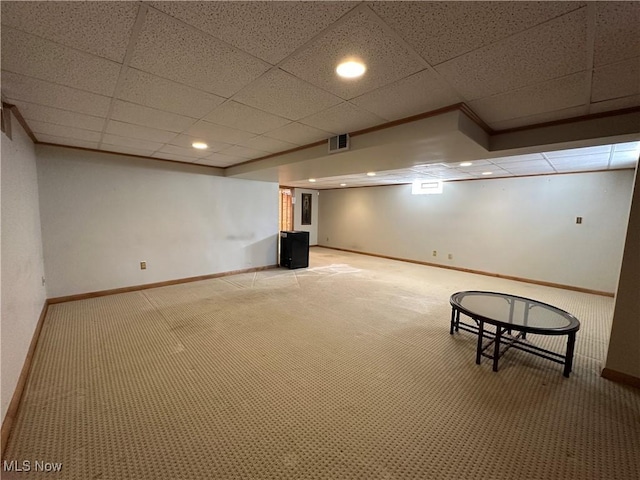 finished below grade area featuring visible vents, light carpet, recessed lighting, a paneled ceiling, and baseboards