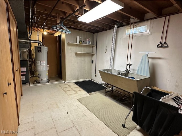 basement with tile patterned floors and water heater