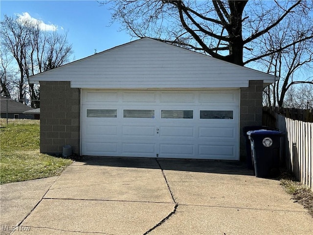 detached garage featuring fence