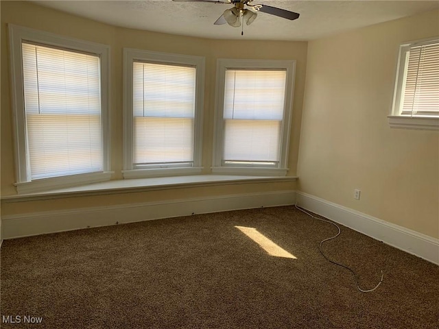 unfurnished room with baseboards, carpet, and ceiling fan