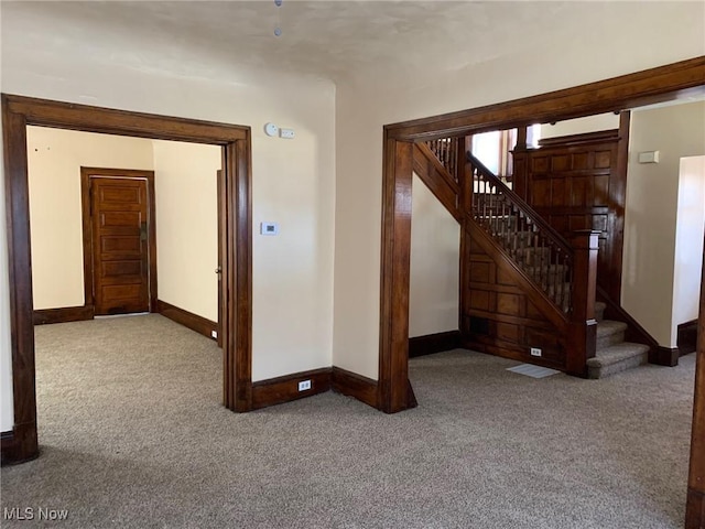 interior space with stairs, carpet flooring, and baseboards