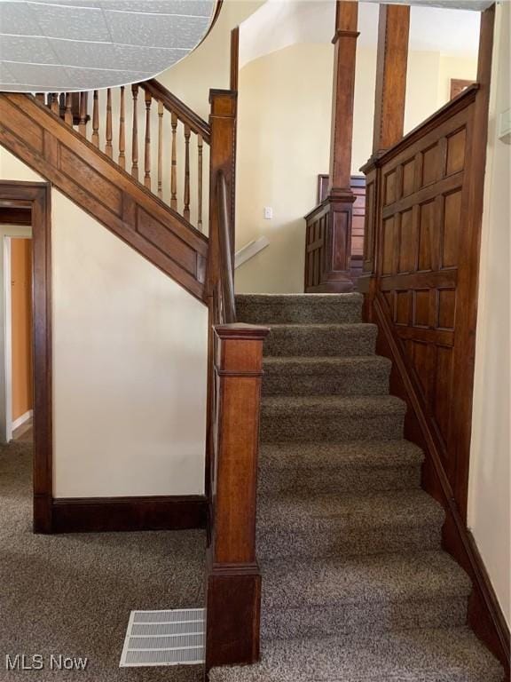 stairs with carpet flooring, baseboards, and visible vents