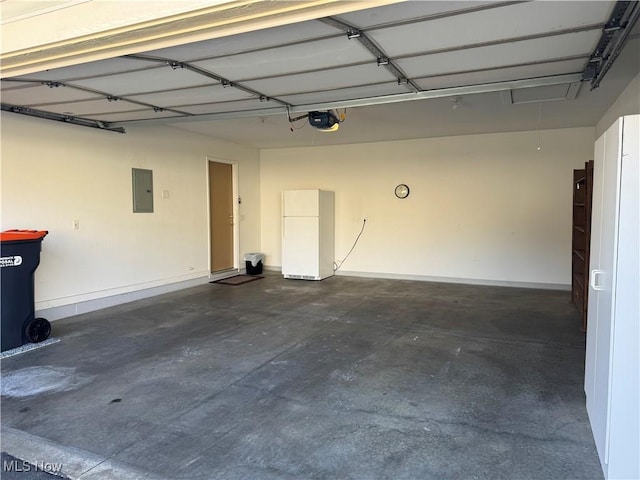 garage with electric panel, a garage door opener, baseboards, and freestanding refrigerator