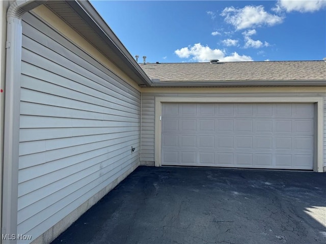 garage with aphalt driveway