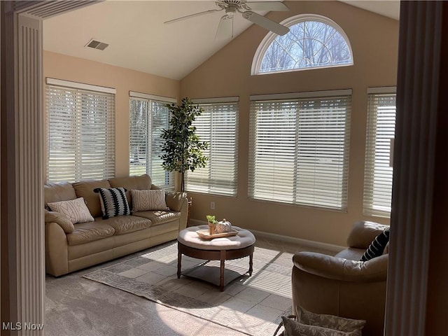 carpeted living room featuring visible vents, high vaulted ceiling, and a ceiling fan