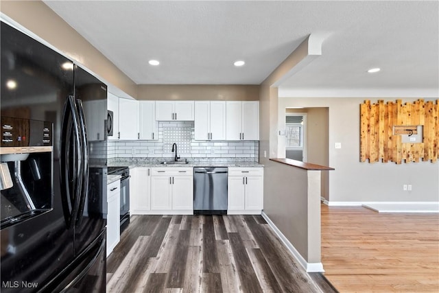 kitchen featuring white cabinets, light stone countertops, black appliances, and dark wood-style flooring