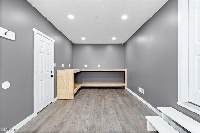 interior space with recessed lighting, baseboards, and wood finished floors