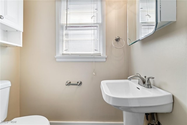 bathroom with toilet and a sink