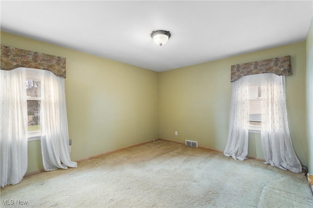 carpeted spare room with visible vents