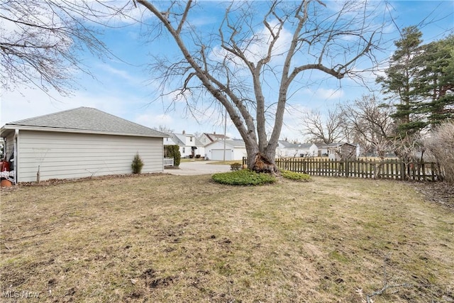 view of yard with a residential view and fence