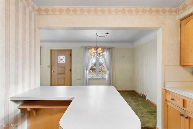 dining room with visible vents, baseboards, a chandelier, and wallpapered walls