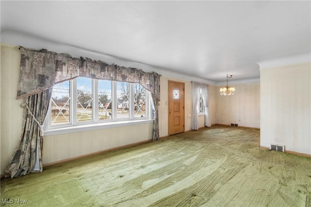 interior space with visible vents, a notable chandelier, and carpet flooring