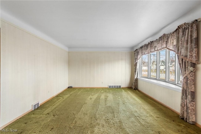 unfurnished room featuring visible vents, baseboards, and carpet floors