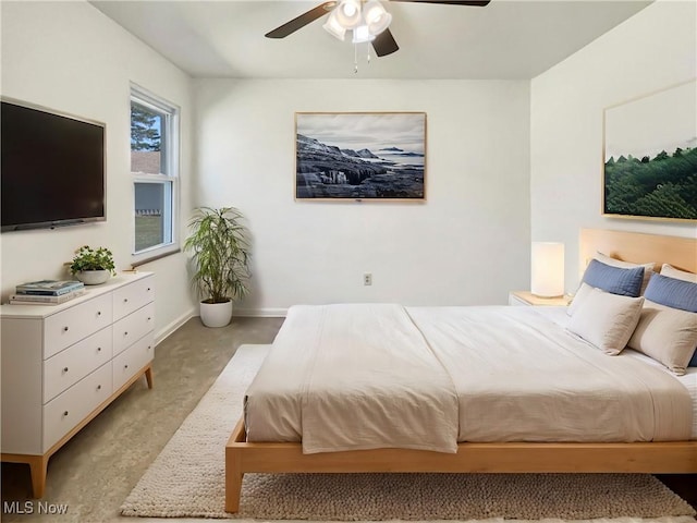 bedroom with light colored carpet, baseboards, and ceiling fan