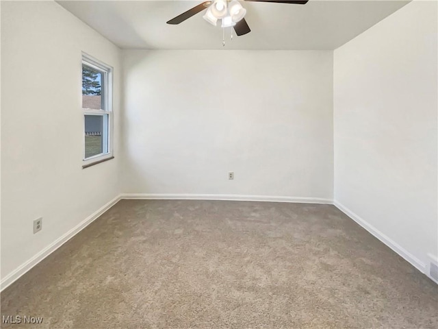 spare room with baseboards, carpet, and a ceiling fan