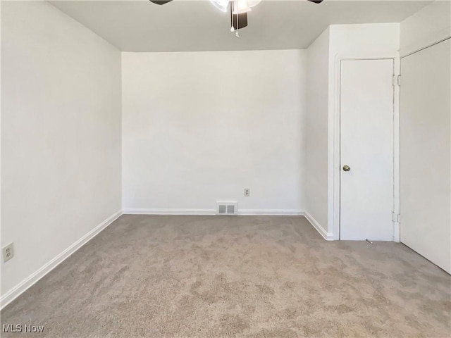 spare room featuring visible vents, carpet, and a ceiling fan