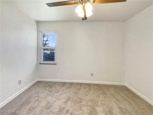 spare room with baseboards, carpet, and ceiling fan