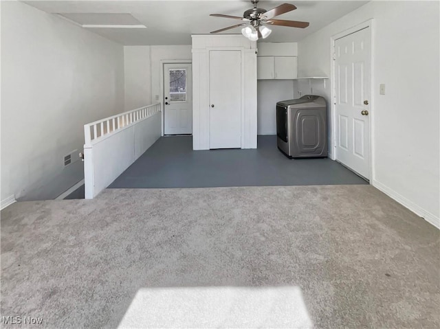 interior space featuring baseboards, washer / dryer, and a ceiling fan