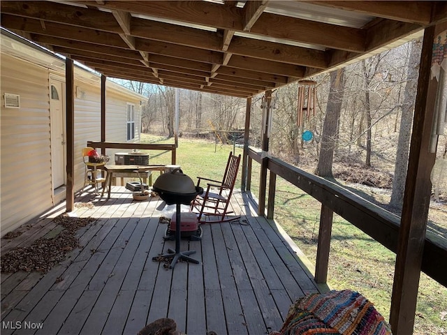 wooden terrace featuring central air condition unit and a lawn