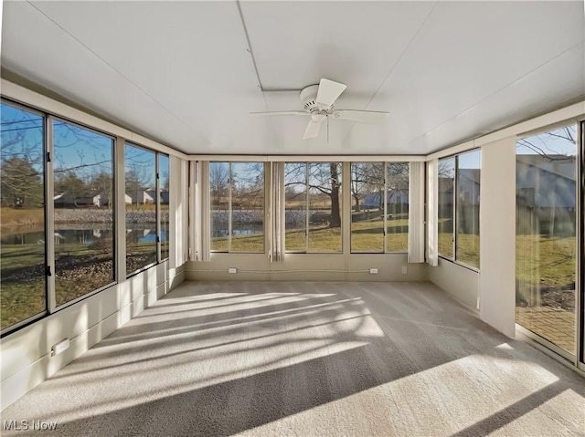 unfurnished sunroom with a ceiling fan and a healthy amount of sunlight