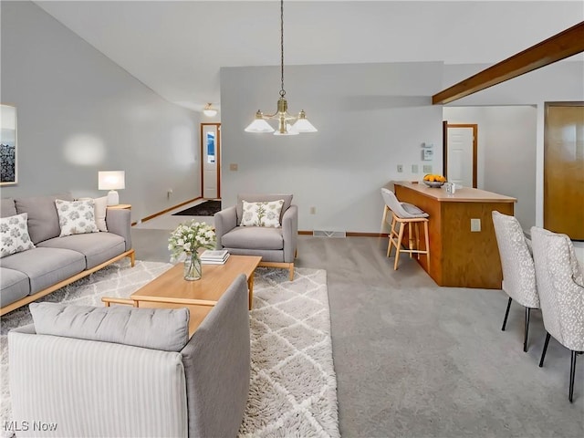 carpeted living room with visible vents, baseboards, lofted ceiling, and an inviting chandelier