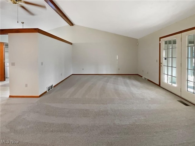 unfurnished living room featuring ceiling fan, vaulted ceiling with beams, visible vents, and light carpet