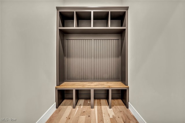 mudroom with baseboards and wood finished floors