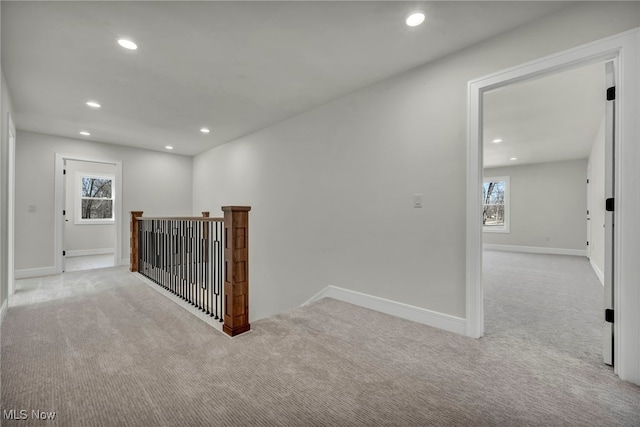 hallway featuring recessed lighting, an upstairs landing, baseboards, and carpet floors