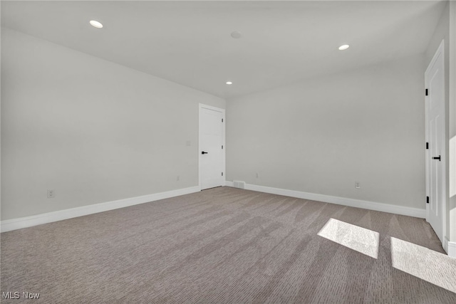 spare room with recessed lighting, baseboards, and carpet