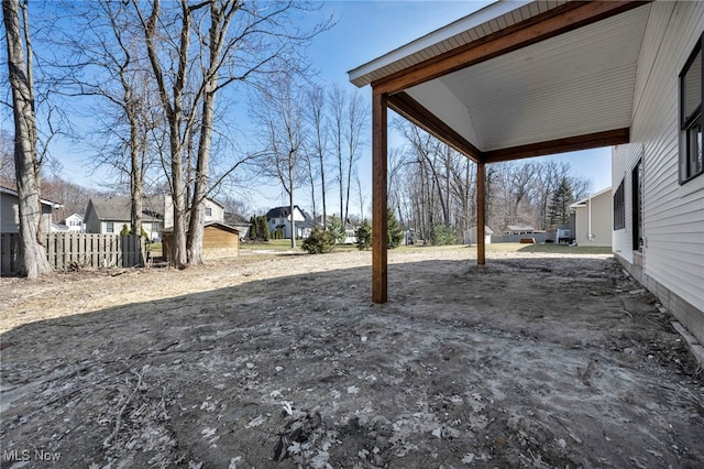 view of yard with a residential view and fence