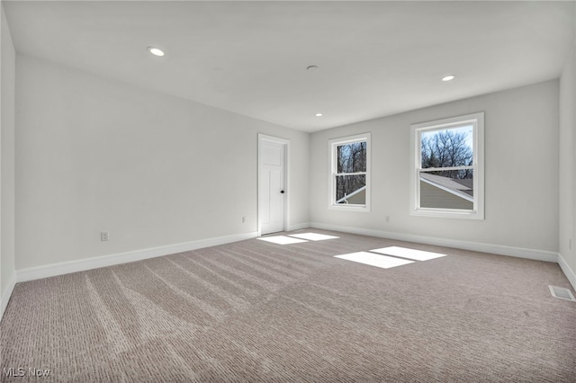 carpeted empty room with visible vents, recessed lighting, and baseboards