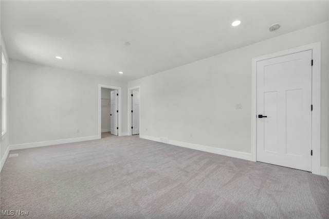 spare room with recessed lighting, baseboards, and carpet flooring