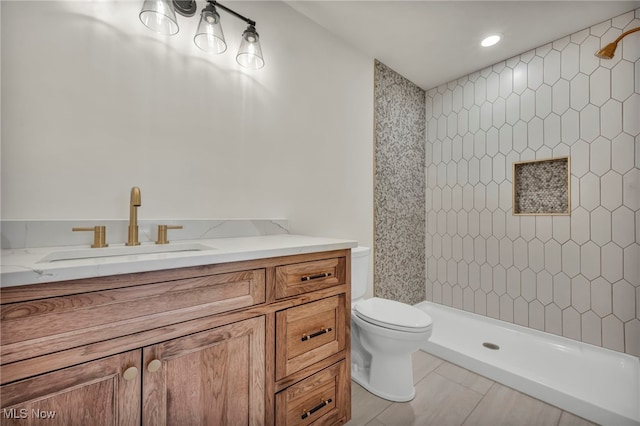 bathroom with vanity, toilet, and a shower stall