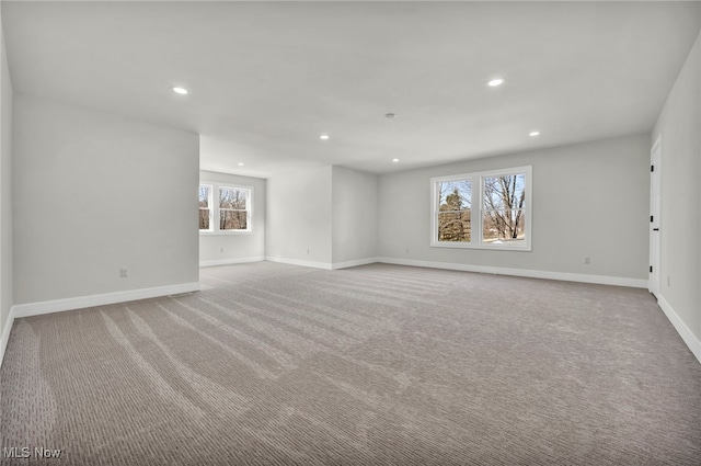 carpeted empty room featuring recessed lighting and baseboards