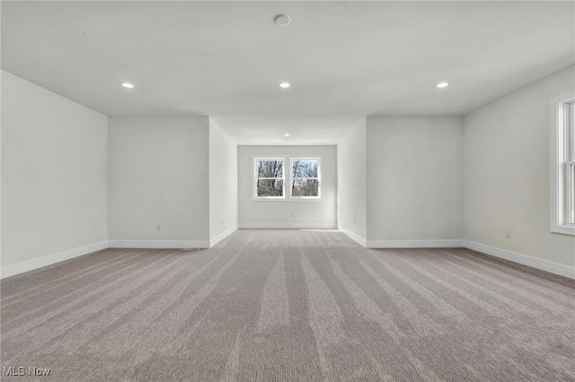 spare room with carpet flooring, recessed lighting, and baseboards