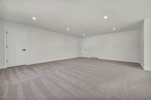 carpeted spare room with recessed lighting, visible vents, and baseboards