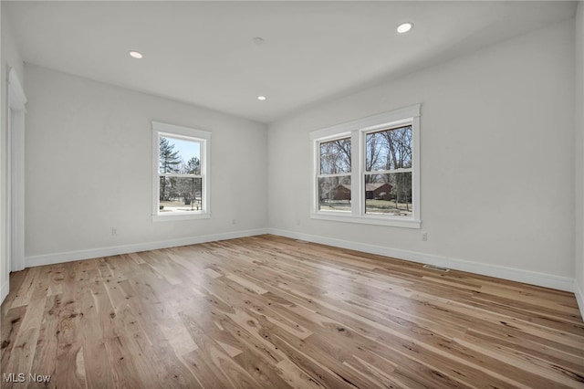 unfurnished room with recessed lighting, baseboards, and light wood-style floors