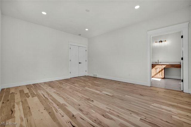 unfurnished room featuring recessed lighting, baseboards, and light wood-style floors