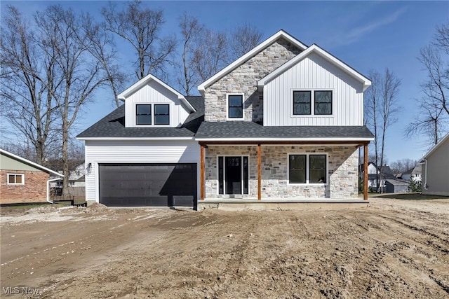 view of front of home featuring stone siding, a porch, dirt driveway, board and batten siding, and a garage