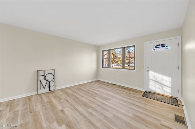 entryway featuring visible vents, baseboards, and light wood finished floors